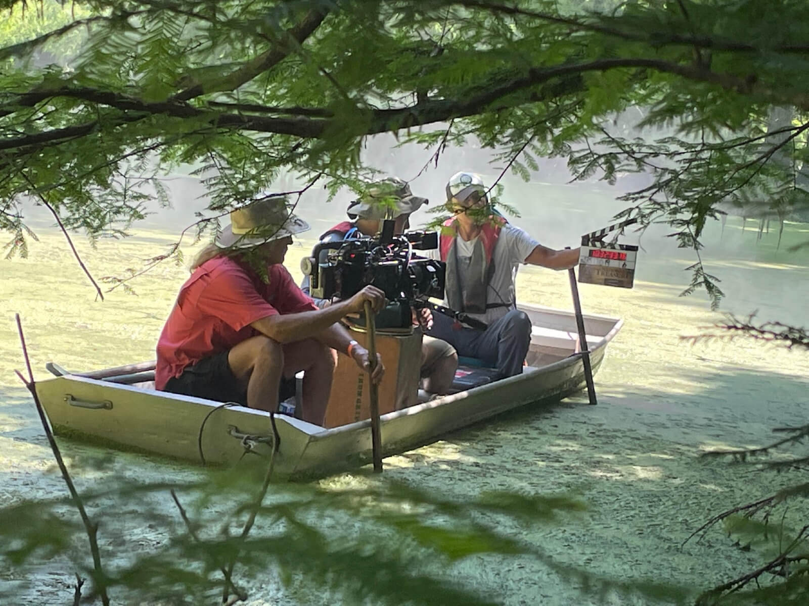 Film crew on boat in swamp